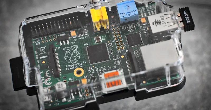 Detailed image of a Raspberry Pi microcomputer circuit board in a clear case.