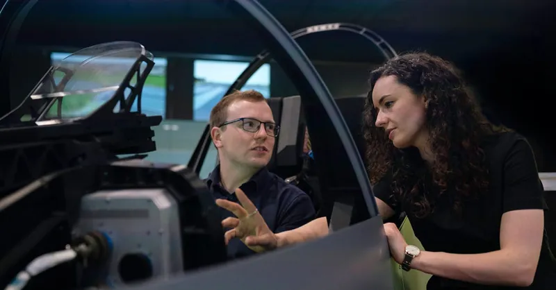 Engineers analyzing aircraft cockpit design during a simulation session.