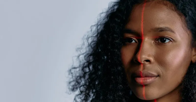 Close-up of a woman scanned with a laser for facial recognition, showcasing advanced technology.