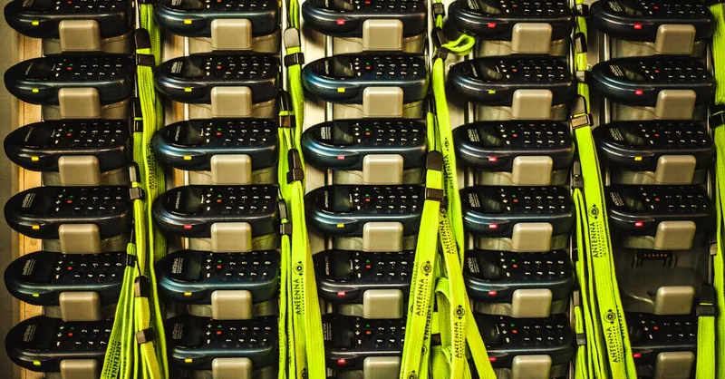 Electronic devices neatly organized in storage with charging cables for efficient management.