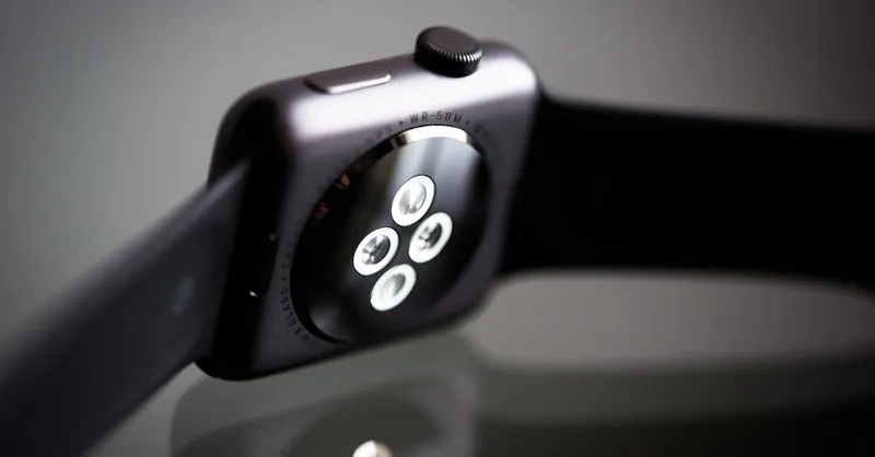 Detailed image of the back sensor of a modern smartwatch showing reflective surface and technology focus.
